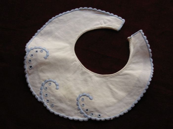 White cotton hand stitched infant bib