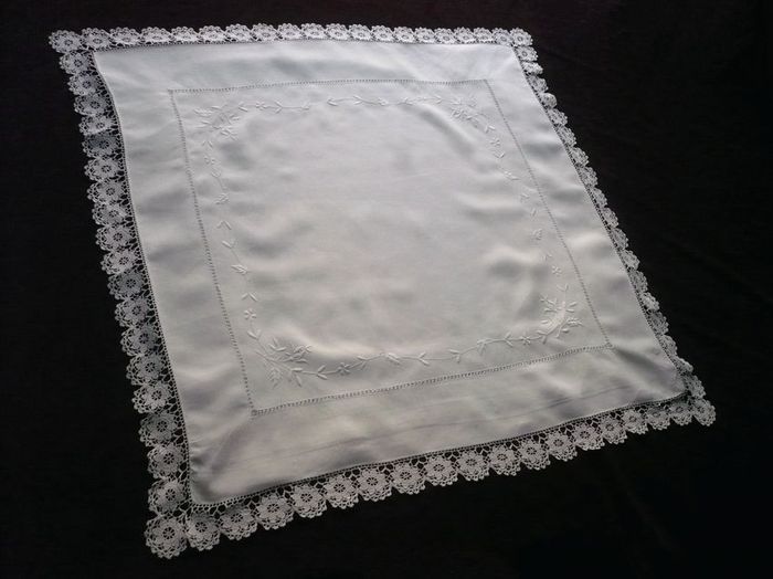 Antique pillow sham with fine embroidered flowers and lace